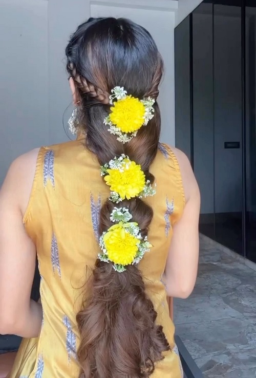 haldi hairstyle adorned with real yellow flowers
